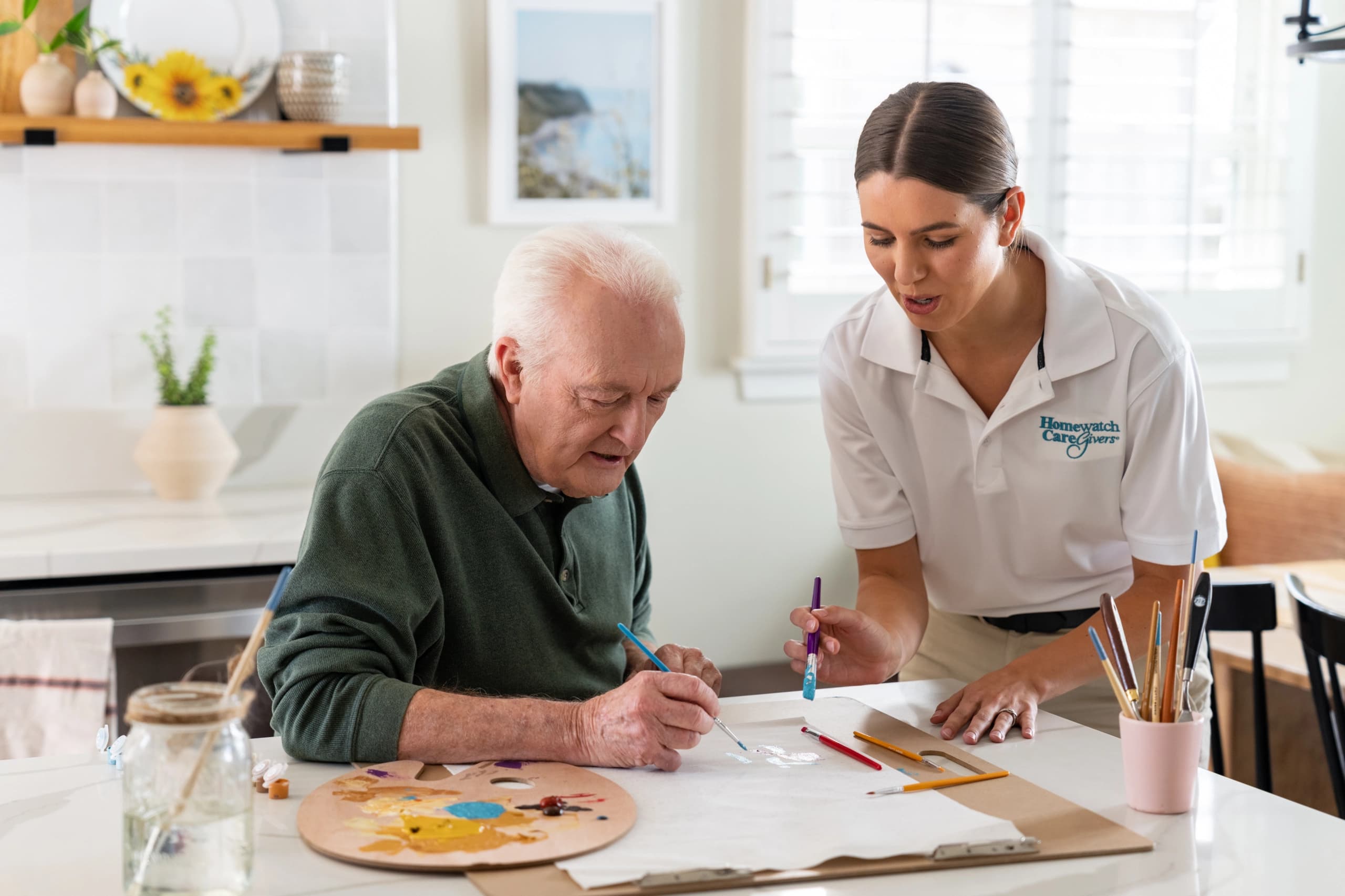 HWCG caregiver and client painting together at home