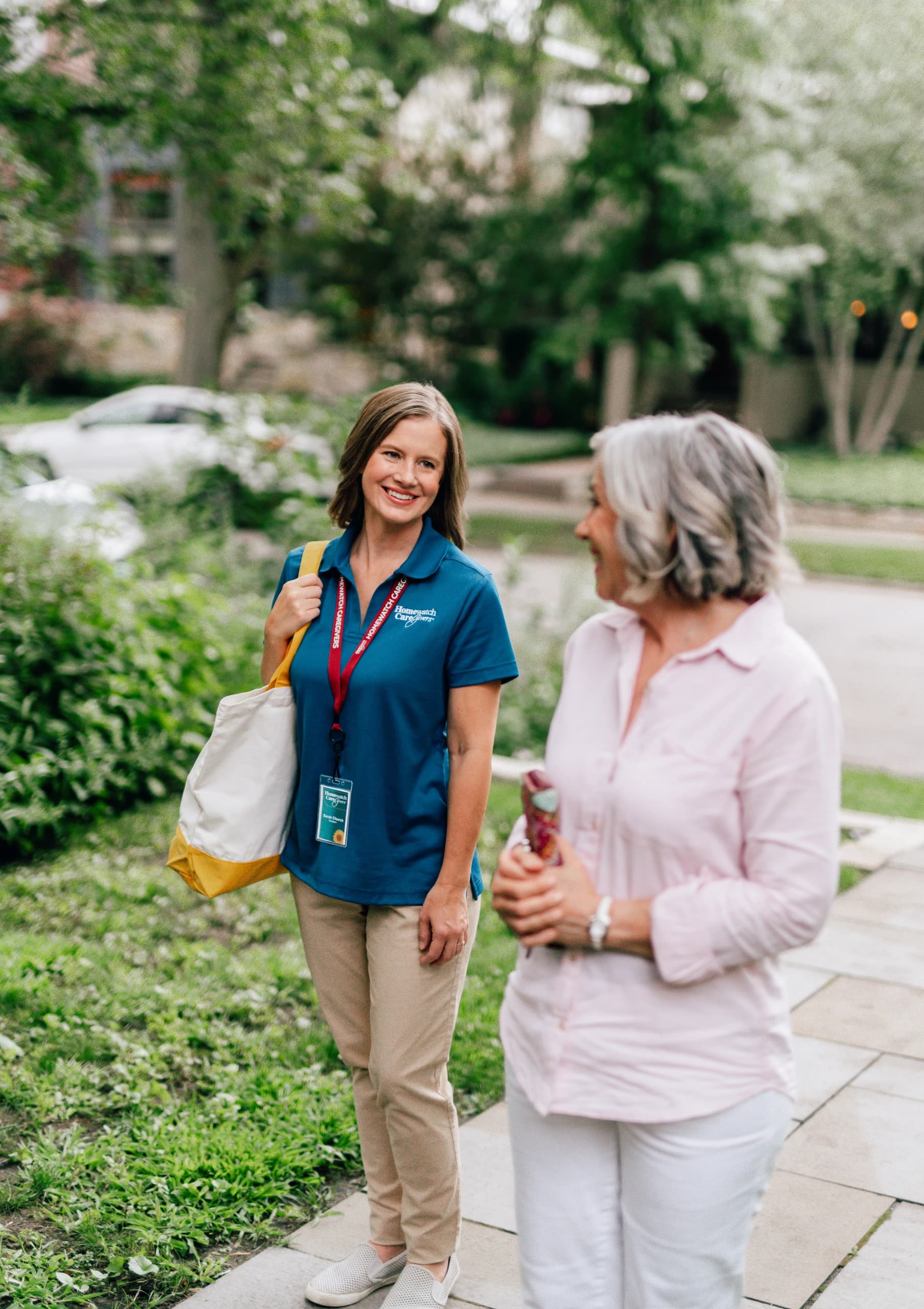 HWCG caregiver walking outdoors with a Houston client